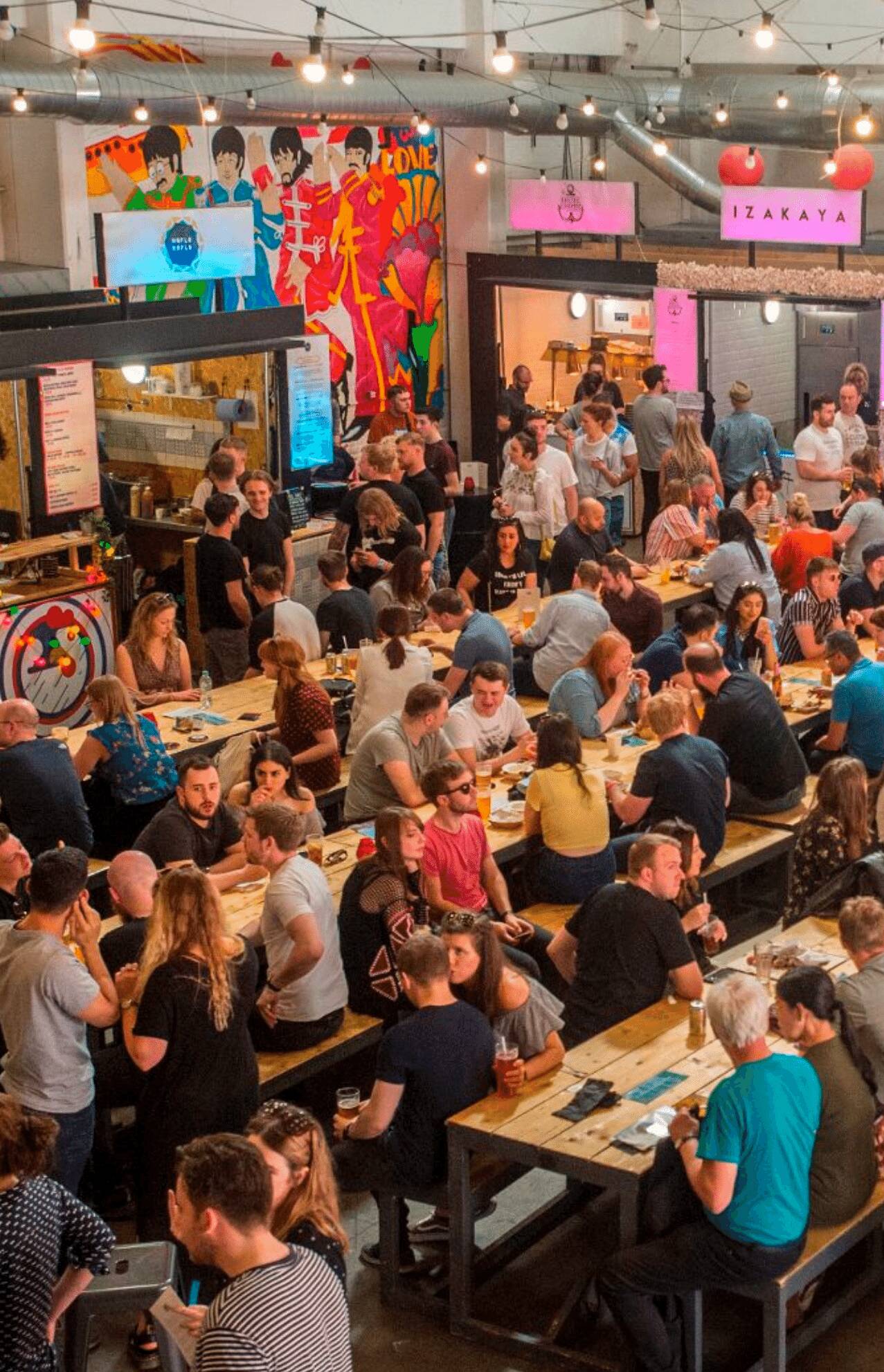 fully occupied seats and tables in Baltic Triangle. The food hall is fully occupied with students who came to eat, drink, and party the night away.